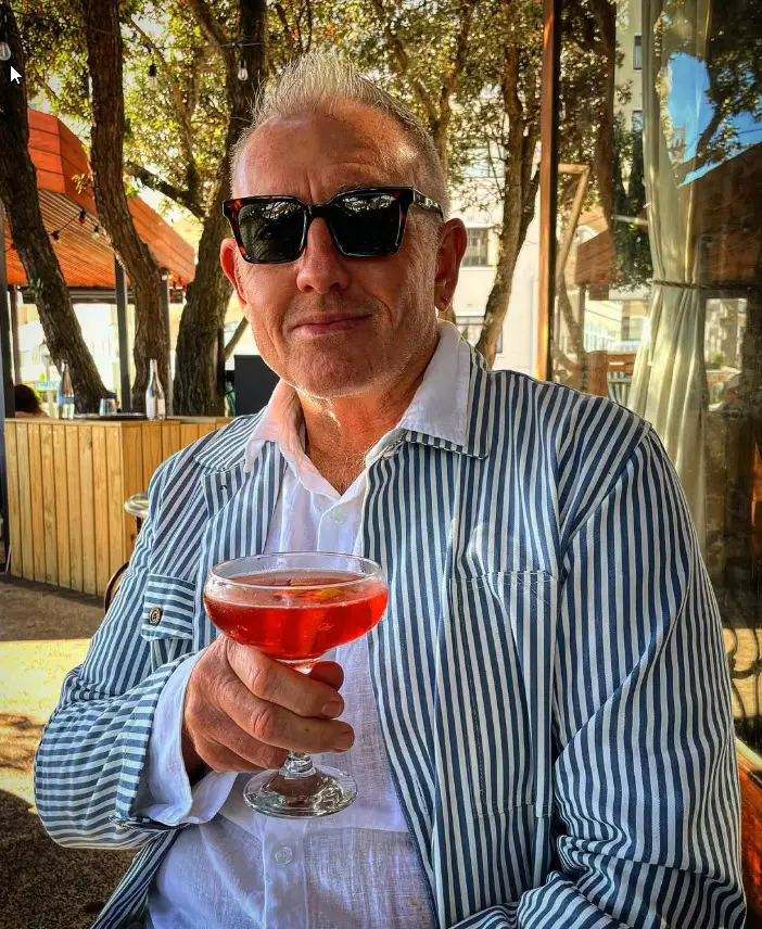 Telford Vice in sunglasses with a cocktail