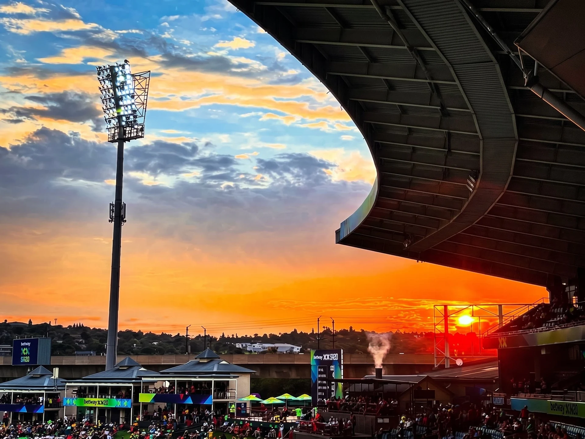 Floodlights against a sunset sky at an SA20 match